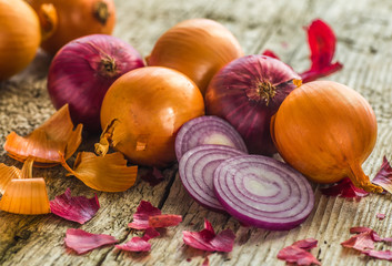 Wall Mural - Onions. Various onions on a board on a background sacking, burlap. Violet onions.