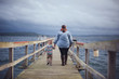 Mother and Son Walking Along Dock at the Pacific Ocean in Washington