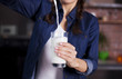© My Ocean studio - Female hands hold a full glass of fresh milk on the kitchen background
