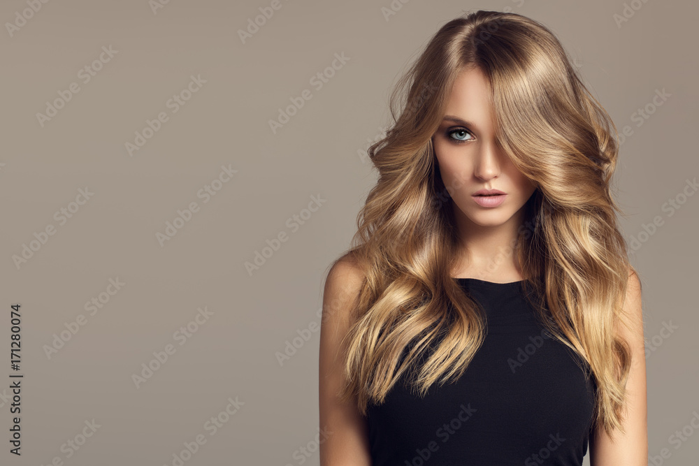 Blond woman with long curly beautiful hair. - obrazy, fototapety, plakaty 