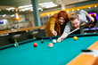 © NDABCREATIVITY - Beautiful couple playing billiards