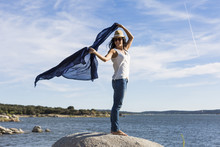 Happy Young Beautiful Woman Playing With A Blue Shawl At The Beach. Fun, Wind And Lifestyle