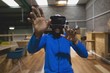 © Wavebreak Media - Man looking through virtual reality simulator in cafeteria