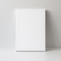 mock up poster. blank vertical canvas, gray wall and floor on background.