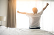 Man wake up and stretching in morning with sunlight