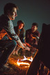 © realstock1 - The smile people warming hands near the bonfire. night time