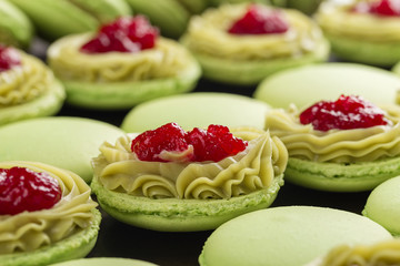 Wall Mural - Green macaroons with pistachios ganache cream and raspberries confit filling