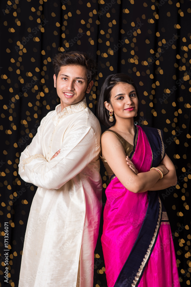 stock photo of cheerful young indian couple in traditional wear in ...