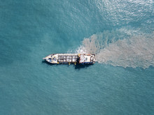 Suction Dredger Ship Working Near The Port - With Mud, Pollution, Brown Muddy Water - Aerial Tip Down Shot