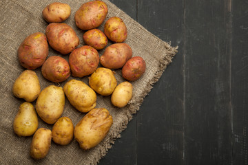 Potatoes on a black wooden background