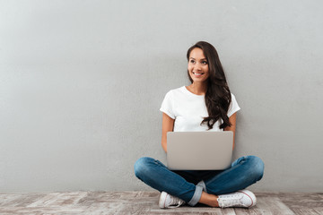 Canvas Print - Happy cheerful asian woman working on laptop computer