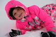 canvas print picture - Mädchen liegt im Schnee