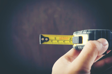 Close up of man hand with tape-measure isolated on background