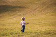 © hypotekyfidler.cz - Child, baby girl, toddler, walking alone on a large meadow in late summer sun, end of August.