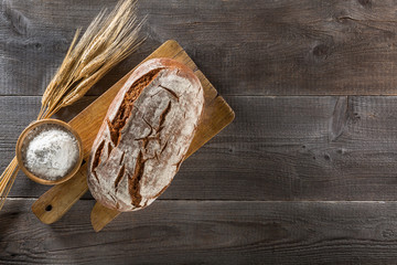 Baked bread on wooden background