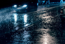 Cars Driving On Street During Heavy Rain At Night, Blurred View