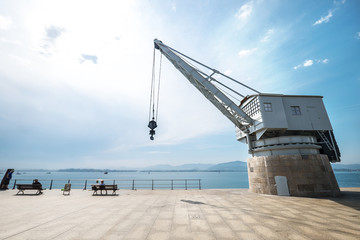 Santander (Spain) sea industrial embankment crane wide angle view.