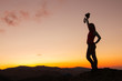 © sefoma - Silhouette of happy joyful young attractive woman jumping and having fun at the mountain against the sunset. Freedom, adventure and leisure vacation concept.