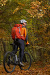 © Aleksey - Mountain biking down the trail. Tourist with backpack travel on bike.