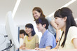 © amanaimages - College Students Studying in Computer Lab