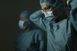 © amanaimages - Male doctors getting ready for surgery