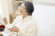 © amanaimages - Patient eating meal in hospital bed