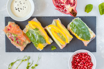 Canvas Print - raw spring rolls with vegetables on slate