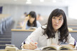 © amanaimages - Students at lecturetaking notes