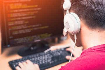 the abstract image of the asian programer developing the software by the desktop computer. the conce