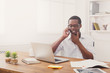 © Prostock-studio - Young black businessman talking on mobile in modern white office