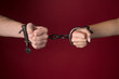 © andreysafonov - male and female hands are handcuffed.