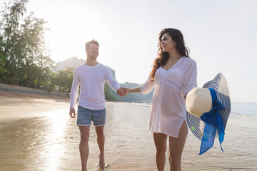 Wall Mural - Couple On Beach Summer Vacation, Beautiful Young Happy People In Love Walking, Man Woman Smile Holding Hands Sea Ocean Holiday Travel