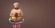 © Studio Romantic - Funny fat bearded man in a swimsuit in for swimming inflatable ring.