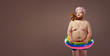 © Studio Romantic - Funny fat bearded man in a swimsuit in for swimming inflatable ring.