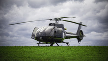 Black Helicopter Standing On The Green Grass