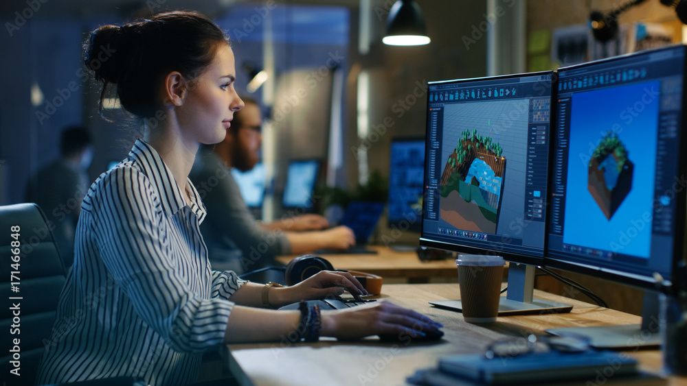 Female Game Developer Works on a Level Design on Her Personal Computer with Two Displays. She works in a Creative Office Space. - obrazy, fototapety, plakaty 