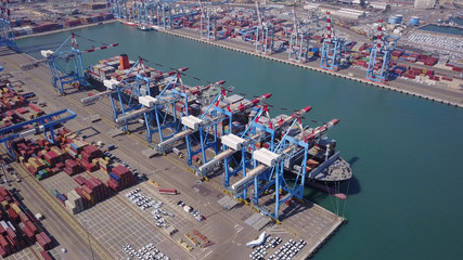 Fully loaded container ship docked at freight port terminal