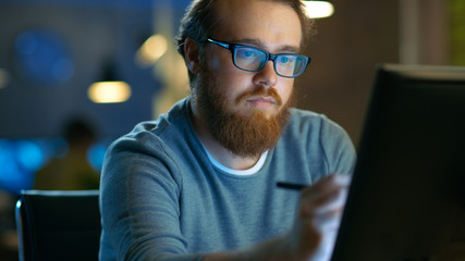 Wall Mural - talented young concept artist drawing on a digital pen display tablet while sitting at his working p