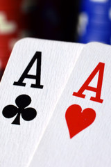 Poster - Pair of aces poker hand close up. Stacks of poker chips on background. Vertical image.