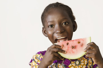 Young African girl eating some watermelon, isolated on white