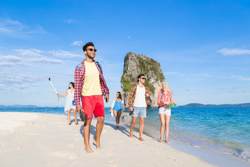 Wall Mural - young people group on beach summer vacation, happy smiling friends walking seaside sea ocean holiday
