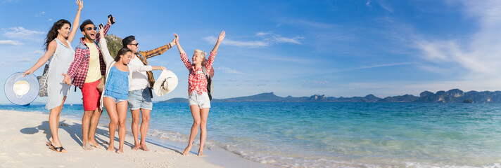 Wall Mural - young people group on beach summer vacation, happy smiling friends walking seaside sea ocean holiday