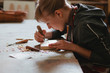 © Sergey Filimonov/Stocksy - Woman carpenter carves a wooden stamp