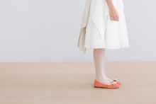 Young Female With White Dress And Orange Shoes