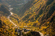 Main highway in Andorra bends and turns, near the Meritxell chapel, through a valley, at the peak of fall foliage colors
