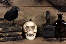 Spooky Black Halloween Decor Against An Old Rustic Wood Background
