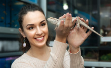 Happy Young Woman Selecting Lizard