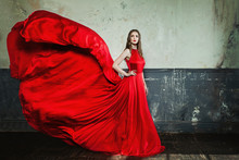 Beautiful Fashion Girl Wearing Red Evening Gown On Vintage Background