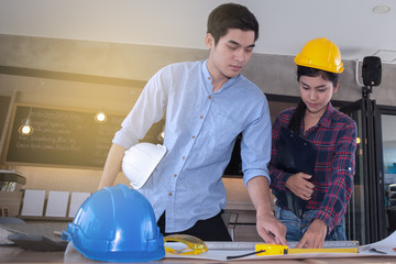 professional male and female engineers working and discuss with blueprint business together