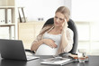 © Africa Studio - Young pregnant woman having headache in home office